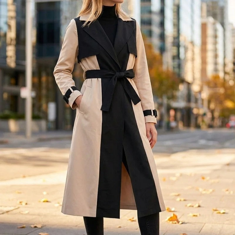 Colorblock Belted Longline Trench Coat worn on a city street, featuring contrasting panels, notch lapels, belted waist, and buckle cuff straps.