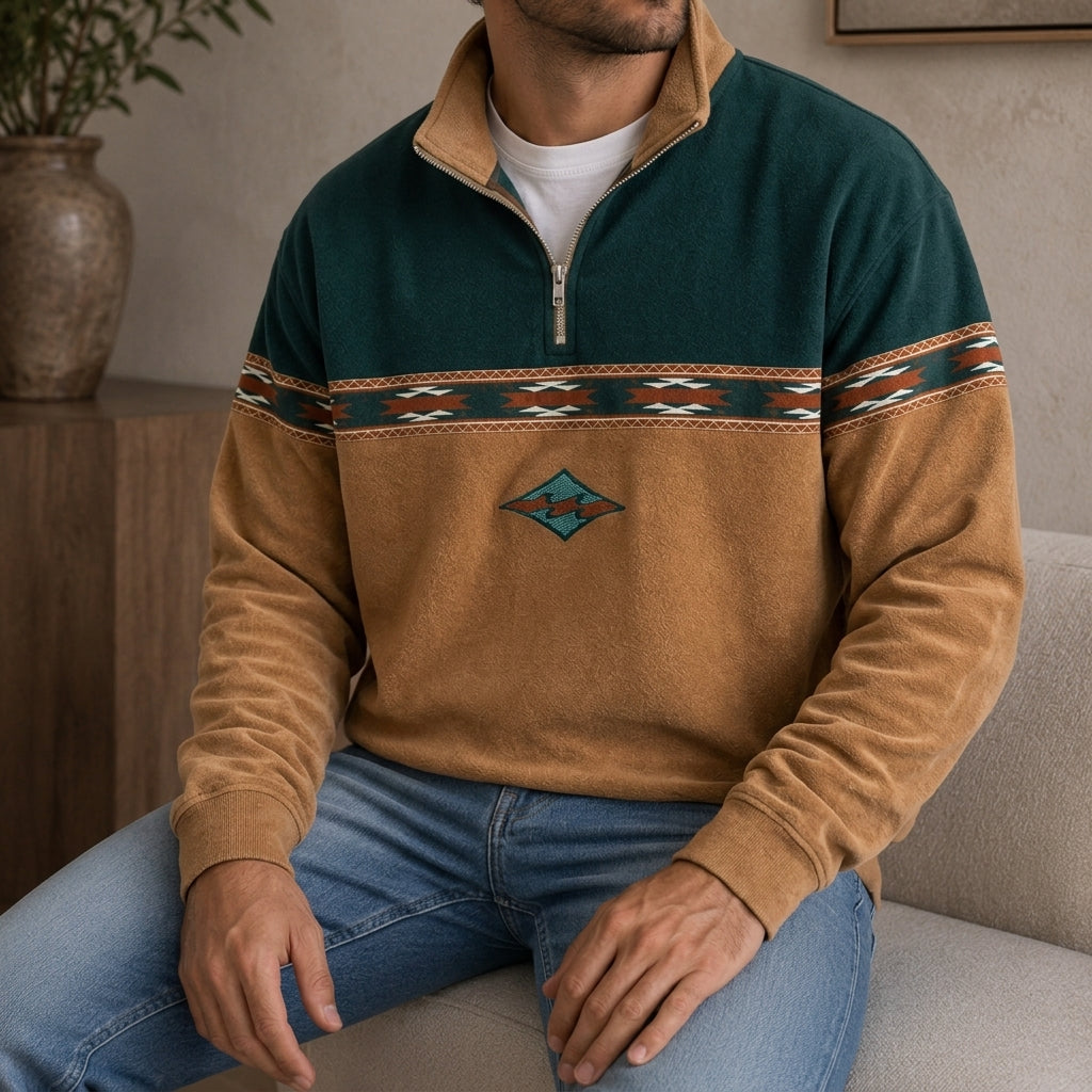 Colorblock brushed quarter-zip pullover worn by a male model, featuring a geometric chest band and embroidered motif.