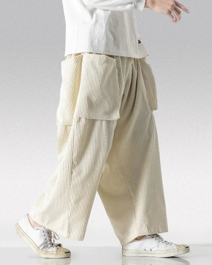 Cream corduroy cargo pants with wide-leg fit and oversized front pockets