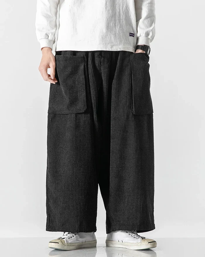 Black wide-leg corduroy cargo pants with large front pockets and elastic waist