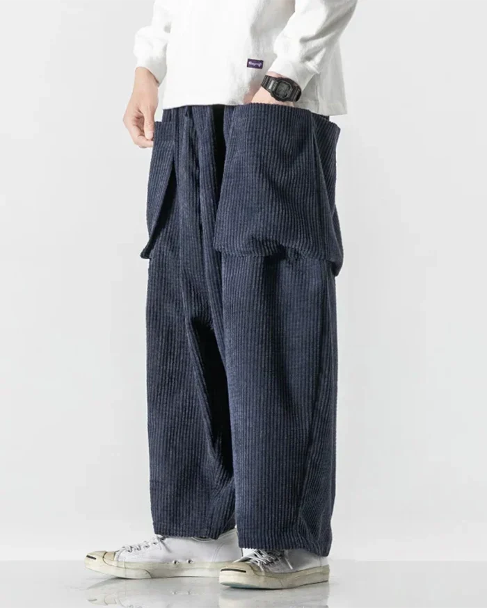 Navy corduroy cargo pants shown from the side with oversized cargo pockets
