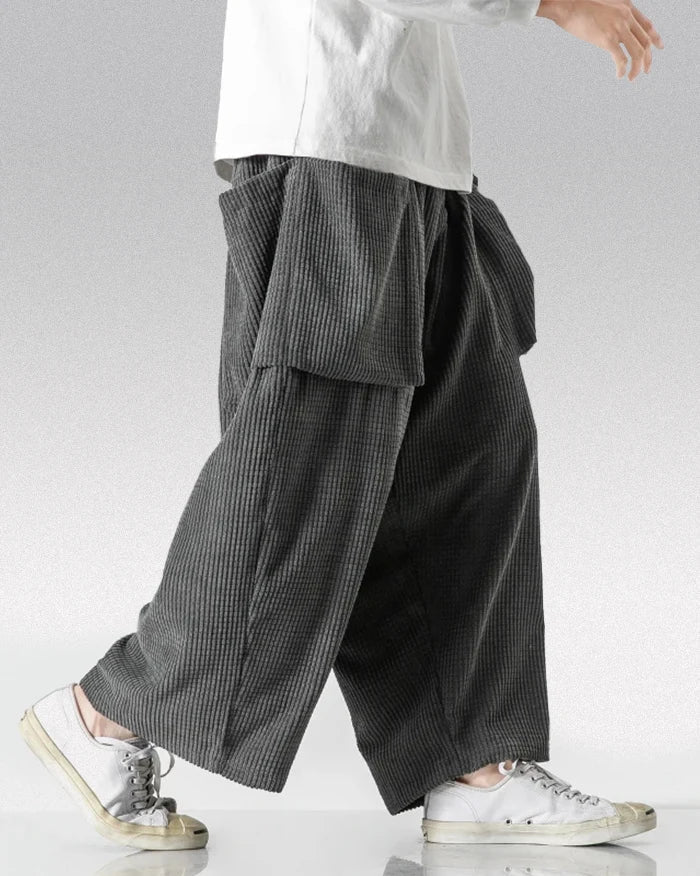 Gray corduroy cargo pants with oversized front pockets, wide legs and elastic waist