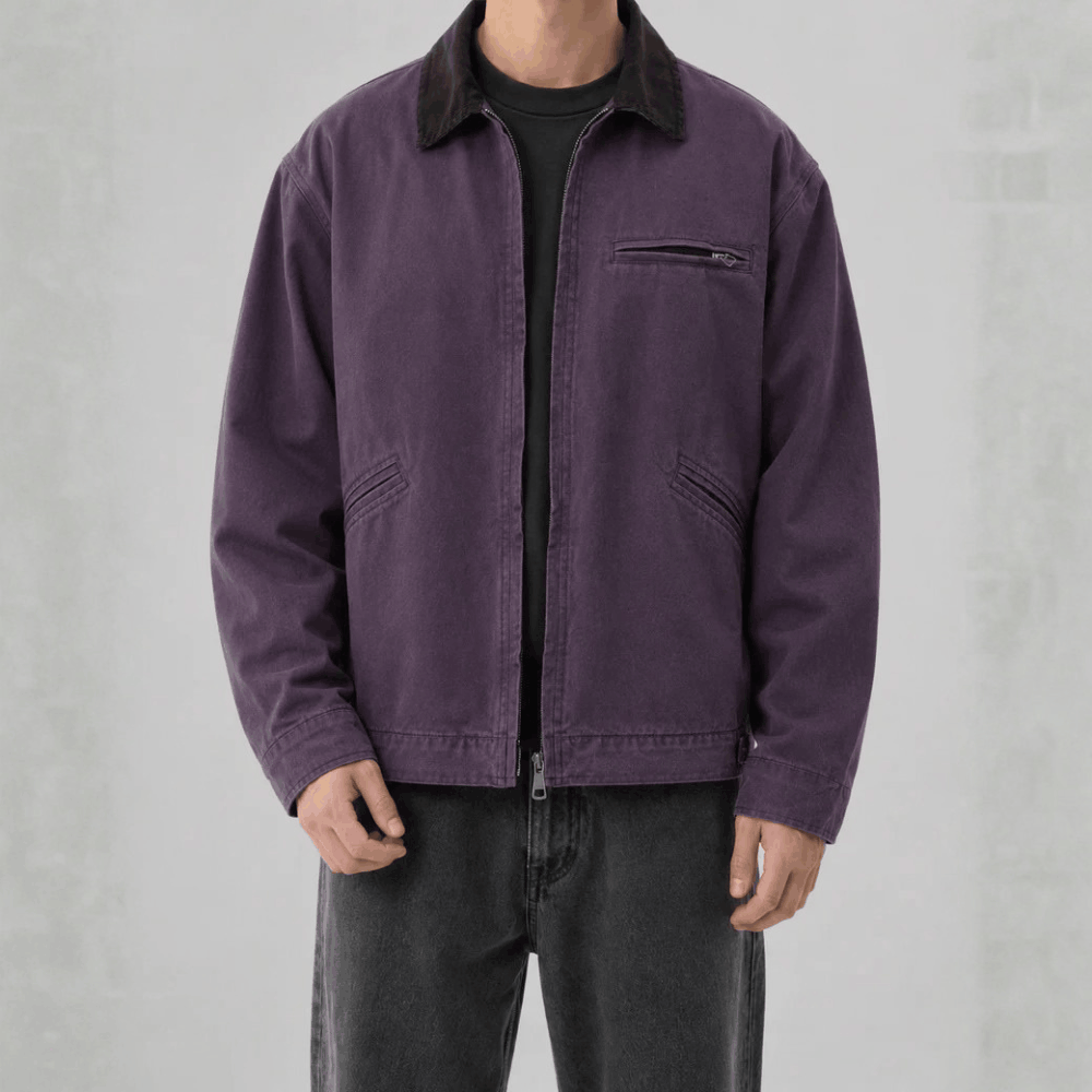 Front view of a model wearing a muted purple cotton canvas barn jacket with a dark brown corduroy collar.