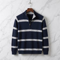 Navy blue cotton knit quarter-zip sweater with contrast horizontal stripes and ribbed mock neck shown on a hanger.