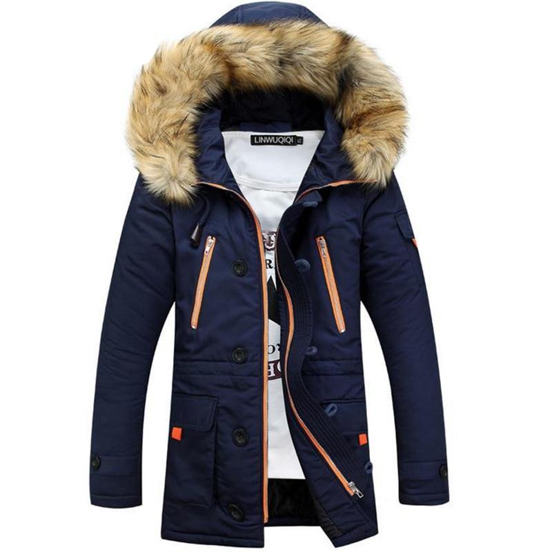Navy blue cotton-padded parka with plush-trim hood, contrast orange zip pockets, and button-tab cuffs in a mid-thigh length.