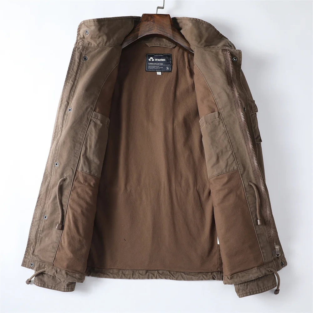 Interior view of the open brown cotton utility jacket showing the soft inner fabric lining, interior pocket, and cinchable drawstring waistband.