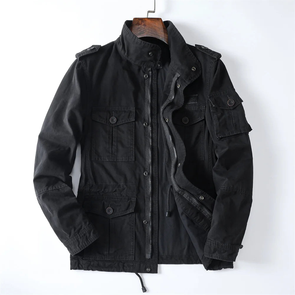 Front product view of the black cotton utility cargo jacket on a hanger displaying the open zip front, stand collar, shoulder epaulets, and multiple cargo pockets.