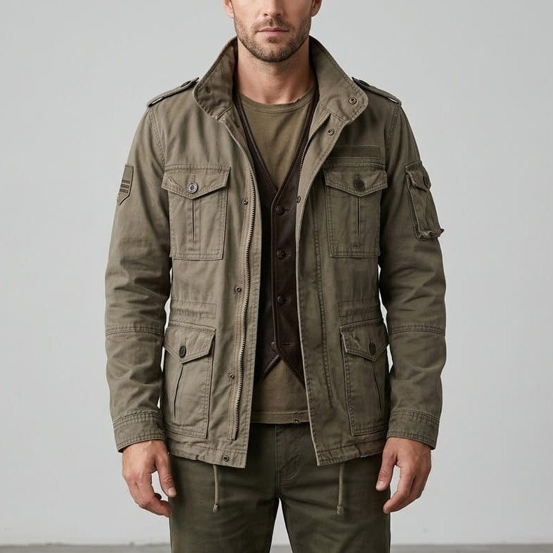 Front view of a model wearing the cotton utility cargo jacket in army green featuring a high stand collar, shoulder epaulets, and four front button-flap pockets.