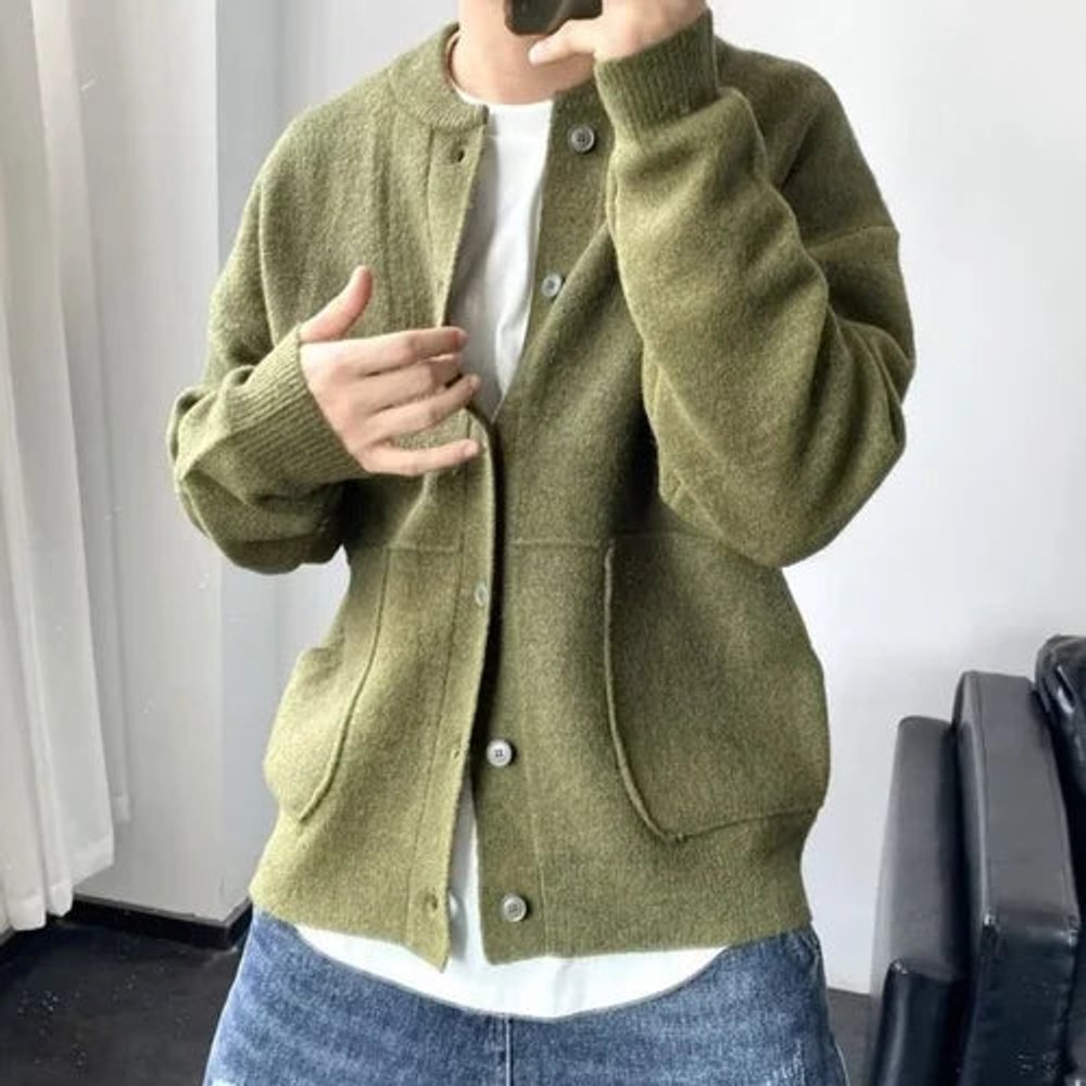 Olive green brushed knit cardigan with a crew neck, button front, and patch pockets worn over a white tee.