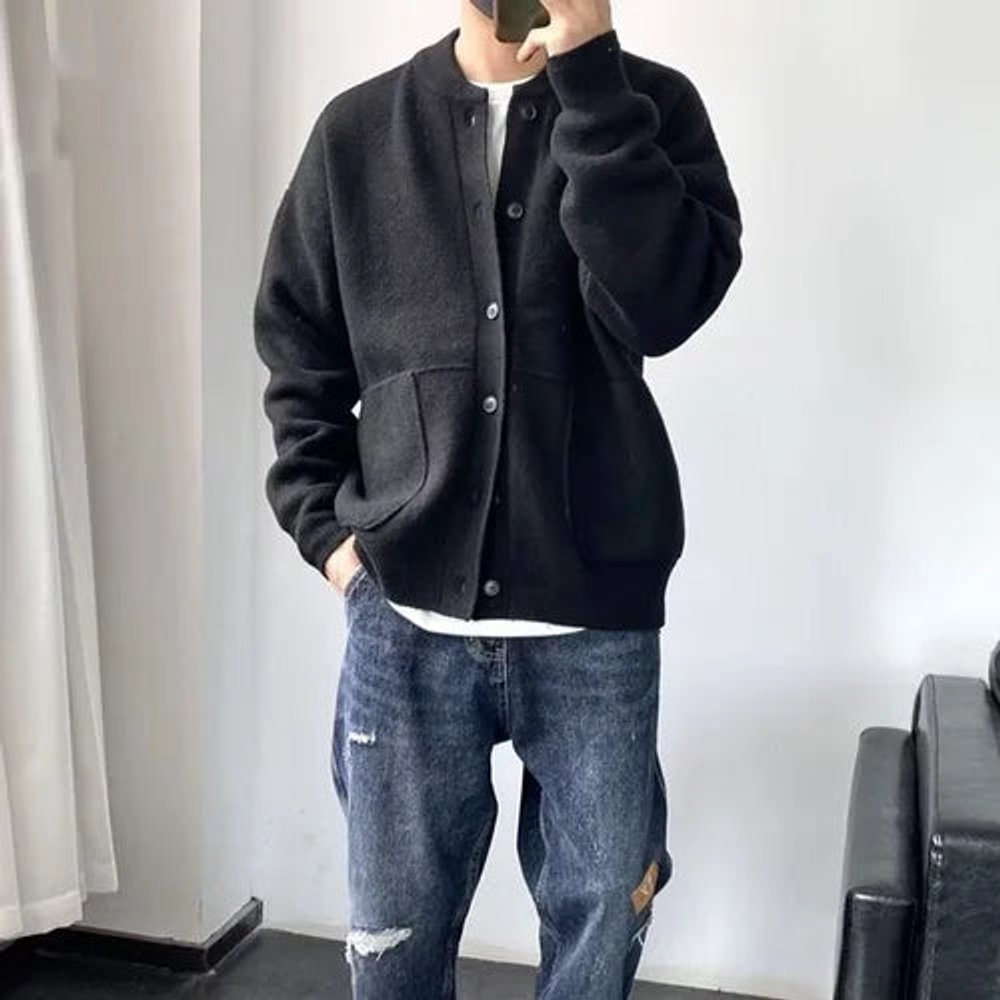 Black brushed knit crew neck cardigan with button front, patch pockets, and a relaxed fit worn over a white tee.