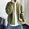 Olive green brushed knit crew neck cardigan with a button-up front, patch pockets, and a relaxed, dropped-shoulder fit.