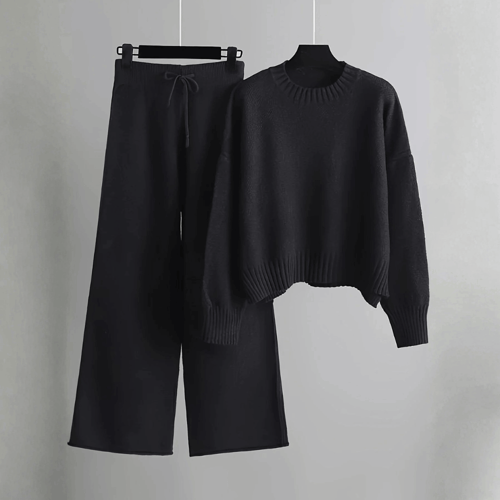 Product hanging view of the relaxed crewneck knit sweater and wide-leg trousers co-ord set in classic black.