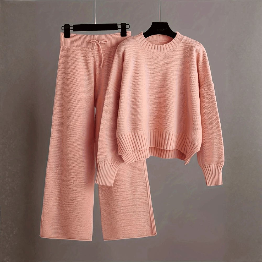 Product hanging view of the crewneck knit sweater and drawstring wide-leg pants set in soft dusty pink.