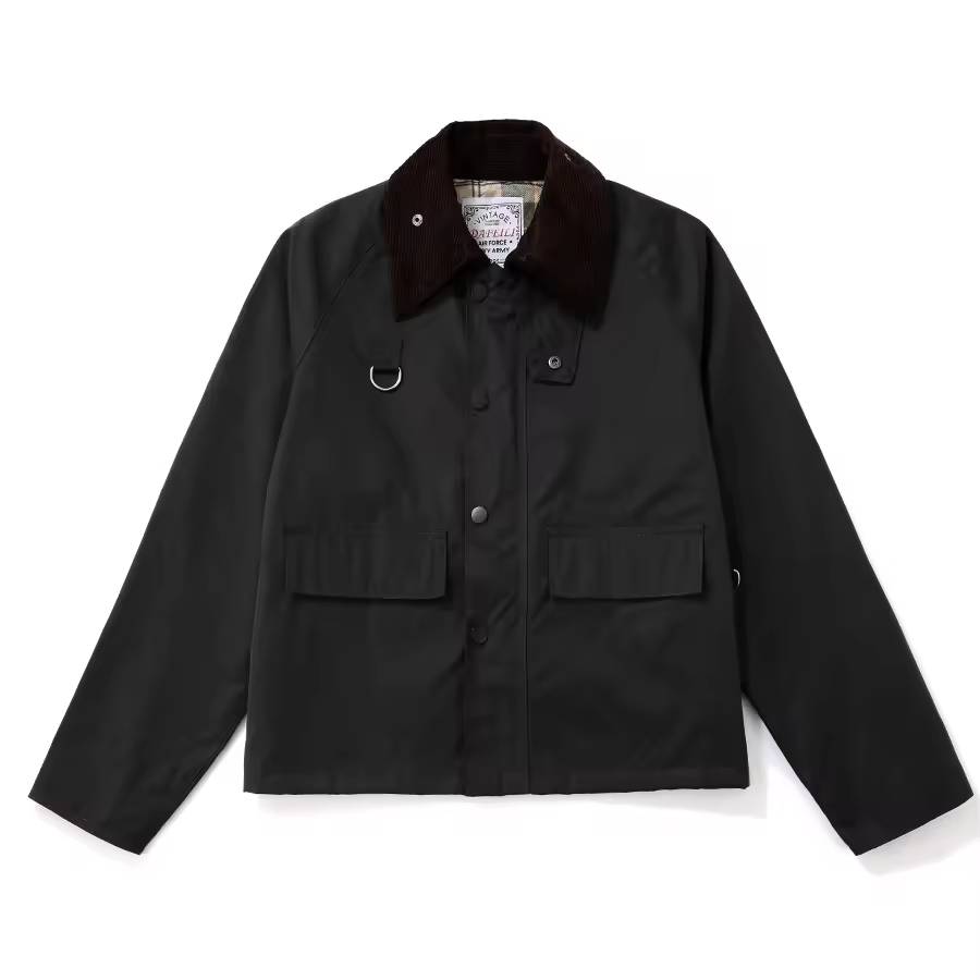 Flat-lay view of the black cropped field jacket displaying the contrast brown corduroy collar, chest D-ring, snap placket, and dual flap pockets.