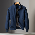 Navy blue weather-resistant bomber jacket with a gingham-lined interior, zip pockets, and a structured, tailored fit.