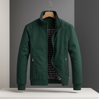 Dark green weather-resistant bomber jacket with a zip front, ribbed cuffs, and a black-and-white gingham lining.