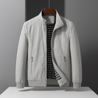 Light grey weather-resistant bomber jacket with a zip front and black-and-white gingham interior lining.
