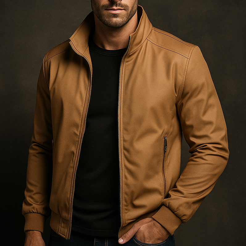 Tan weather-resistant bomber jacket with a zip-up front, ribbed cuffs, and zippered pockets over a black t-shirt.