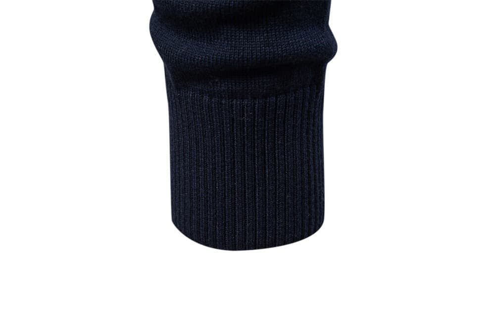 Close-up of the navy knit sweater ribbed sleeve cuff showing the soft textured knit fabric.