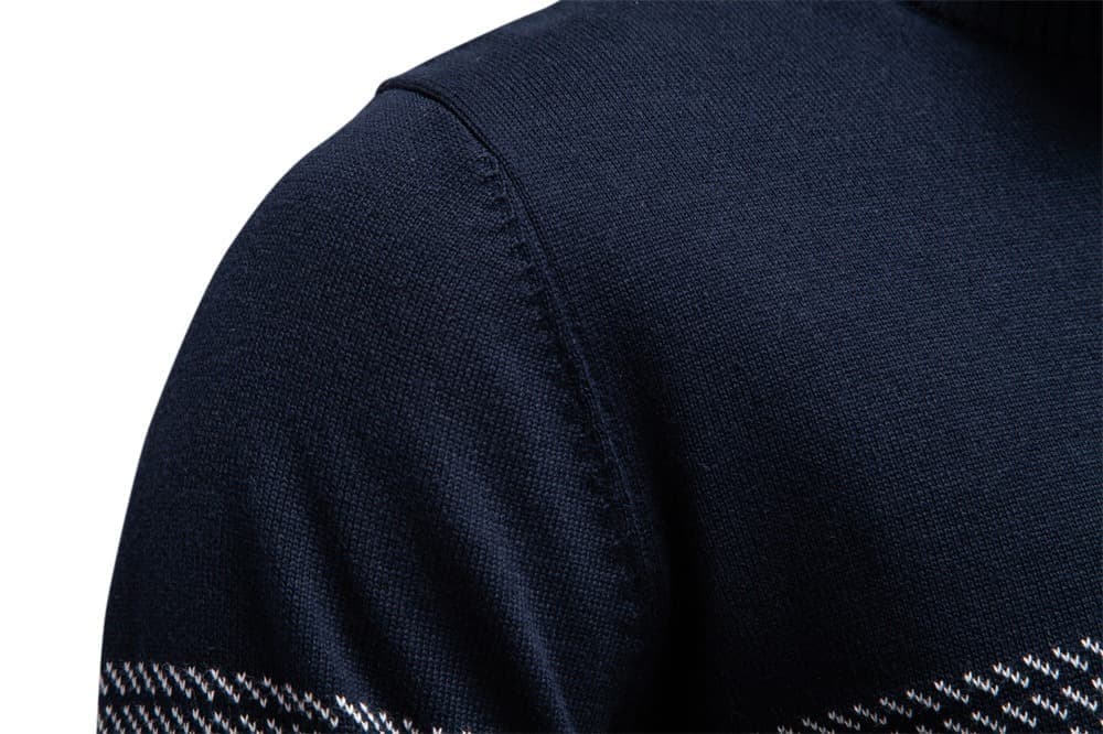 Close-up of the navy knit sweater shoulder showcasing the fine knit texture and textured shoulder detail.