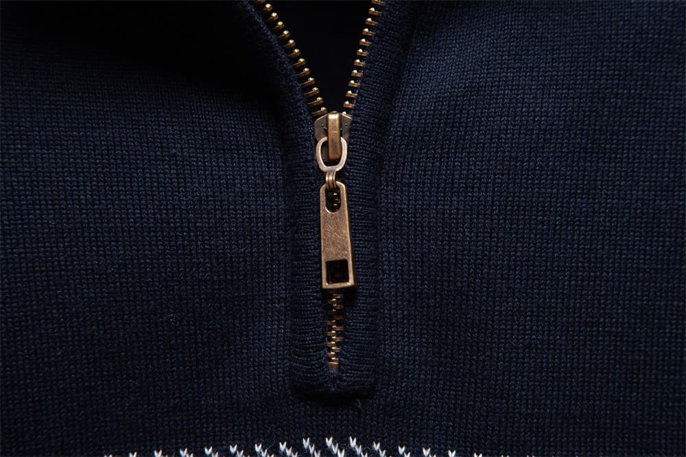 Close-up of the quarter-zip collar with a metal zipper and textured navy knit fabric.