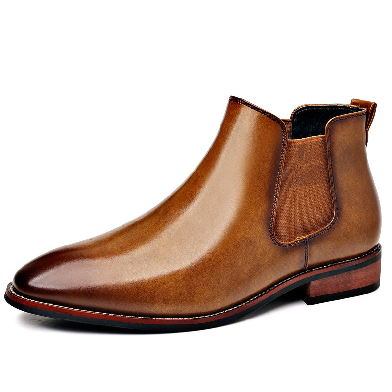 Burnished tan leather Chelsea boot with a pointed toe, elastic side panels, stitched welt, and a low stacked heel.