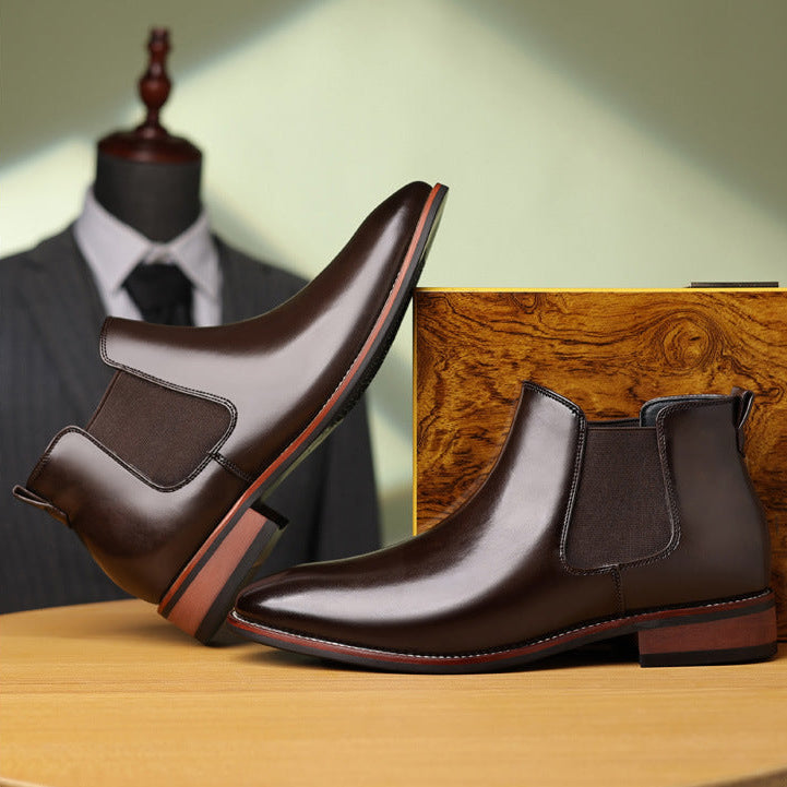 Burnished dark brown leather Chelsea boots with elastic side panels, stitched welt construction, and a low stacked heel.
