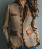 Tailored tweed blazer in tan with brown faux leather trim, button front, and structured fit.