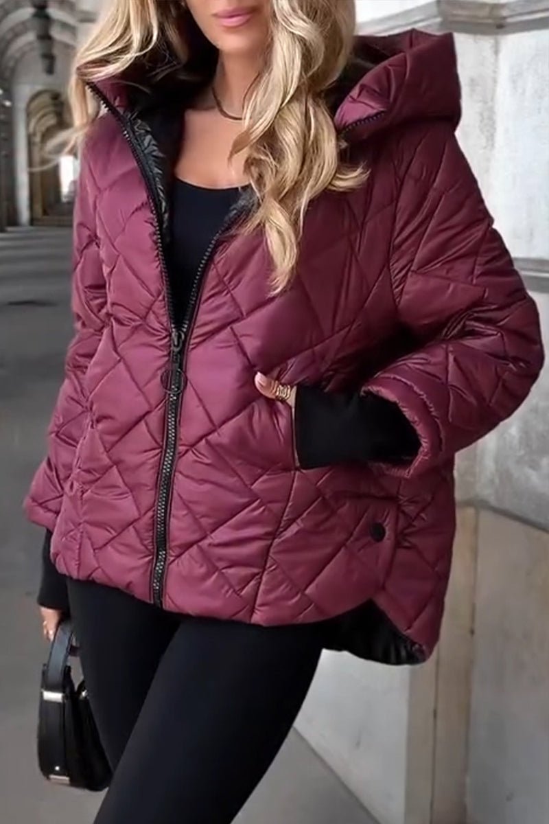 Burgundy diamond-quilted puffer jacket with a relaxed fit, stand collar, attached hood, and black snap-front pockets.