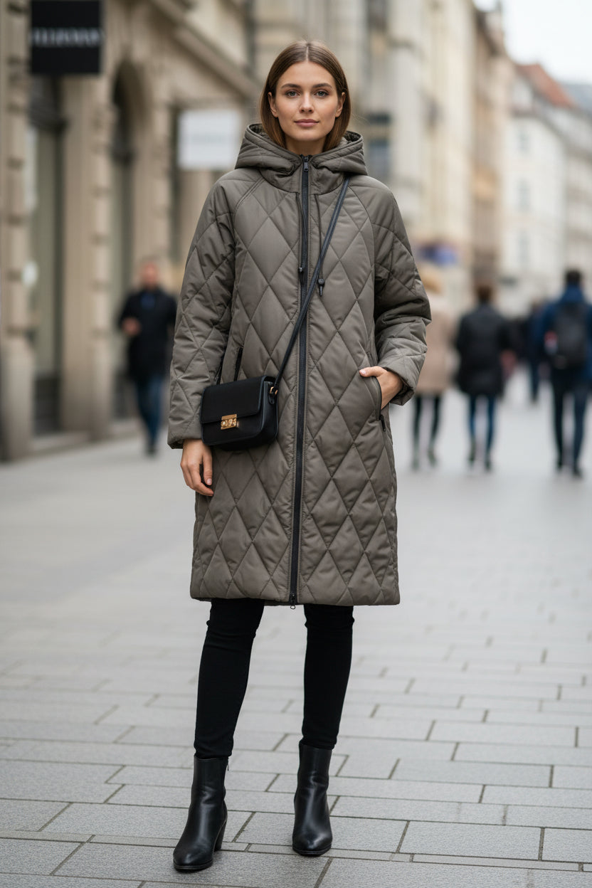 Gray Diamond-Quilted Longline Coat worn by a female model, featuring a drawstring hood, diamond-quilted construction, two-way zip front, and longline silhouette.