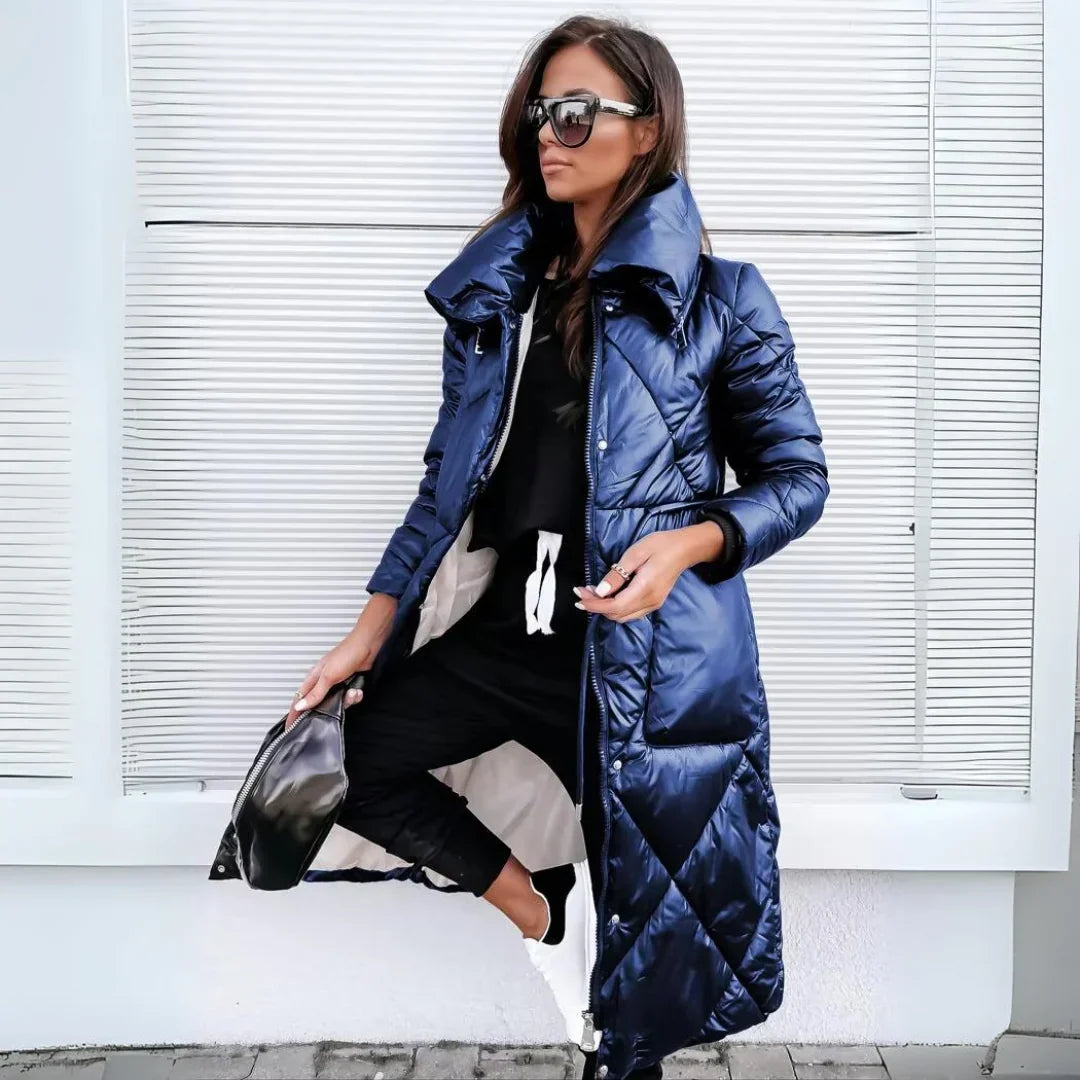 Navy blue longline puffer coat with a high-shine finish, diamond quilting, and an oversized funnel collar.