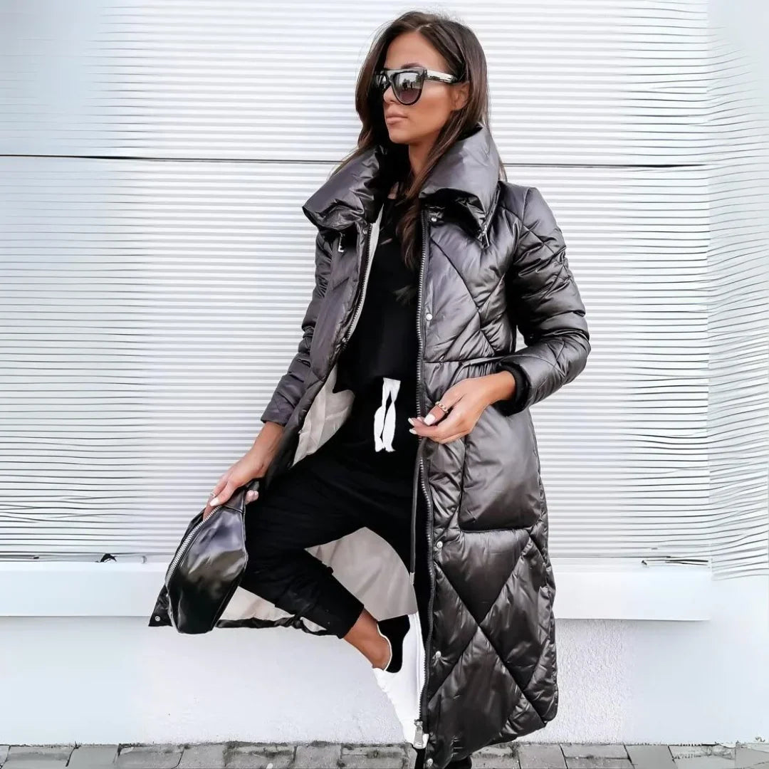 Black longline puffer coat with diamond quilting, high-shine finish, and oversized funnel collar worn over black joggers.