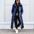 Longline navy blue puffer coat with diamond quilting, high-shine finish, and an oversized funnel collar worn open.