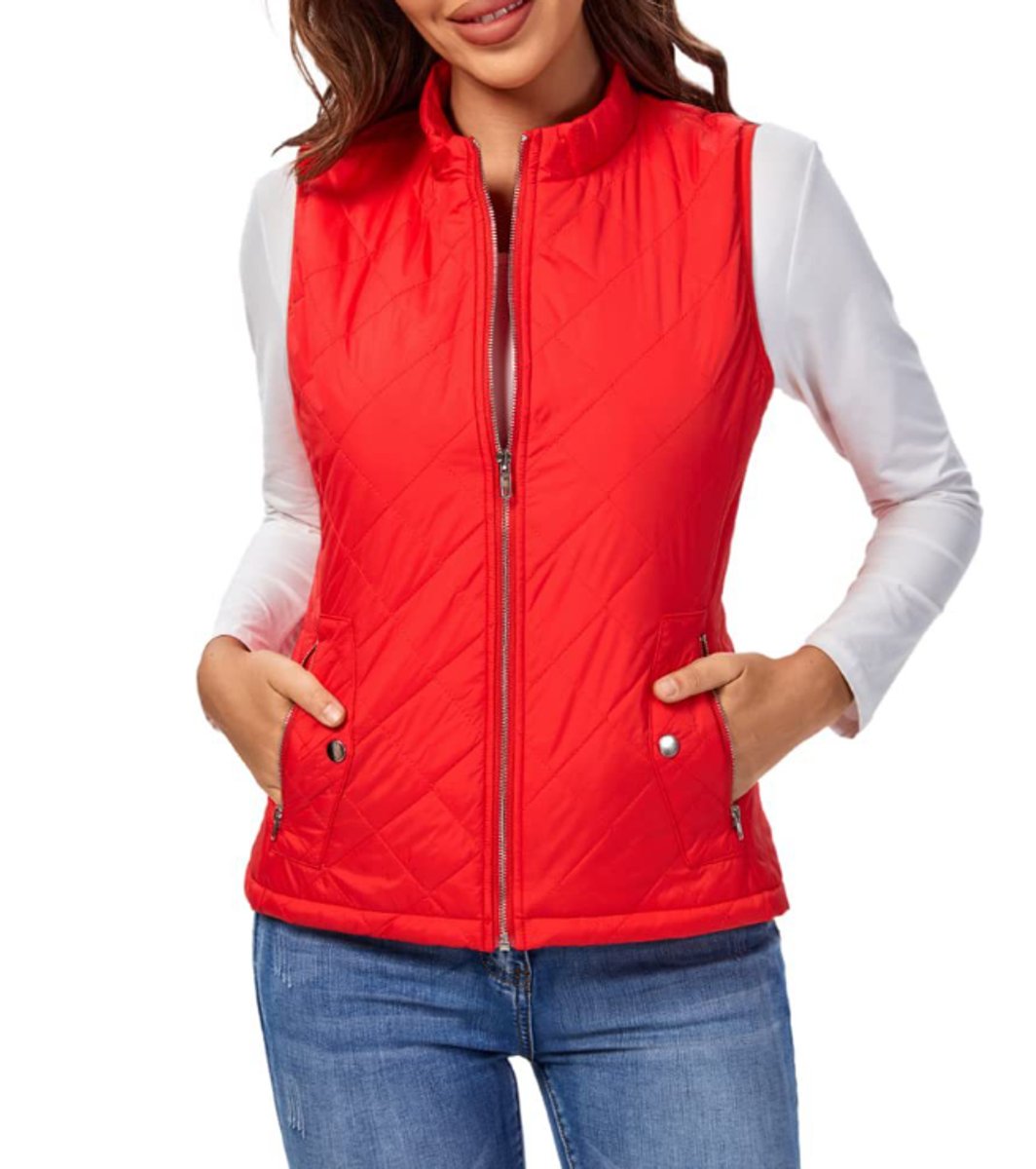 Front view of a model wearing the diamond-quilted zip-up vest with stand collar in red paired with blue jeans.