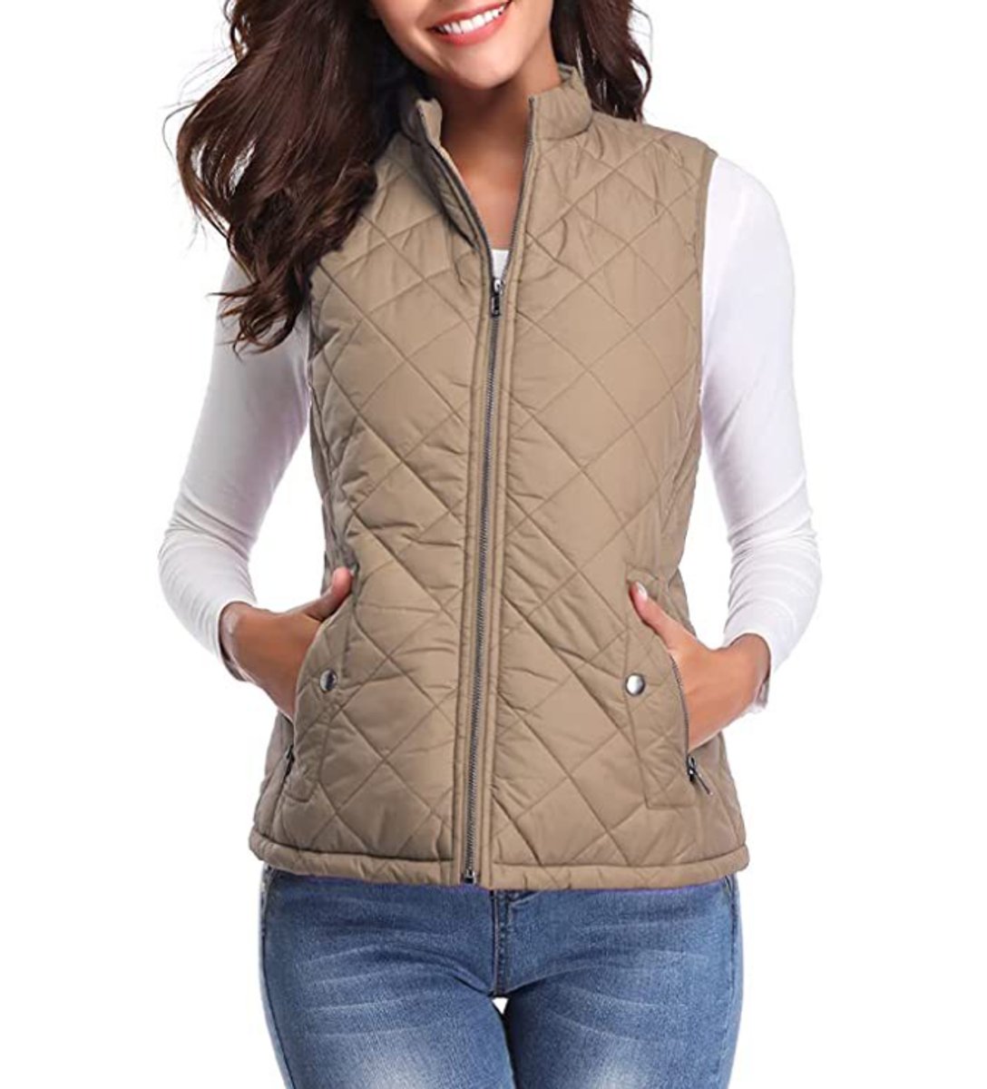 Front view of a model wearing the diamond-quilted zip-up vest with stand collar in light brown paired with blue jeans.