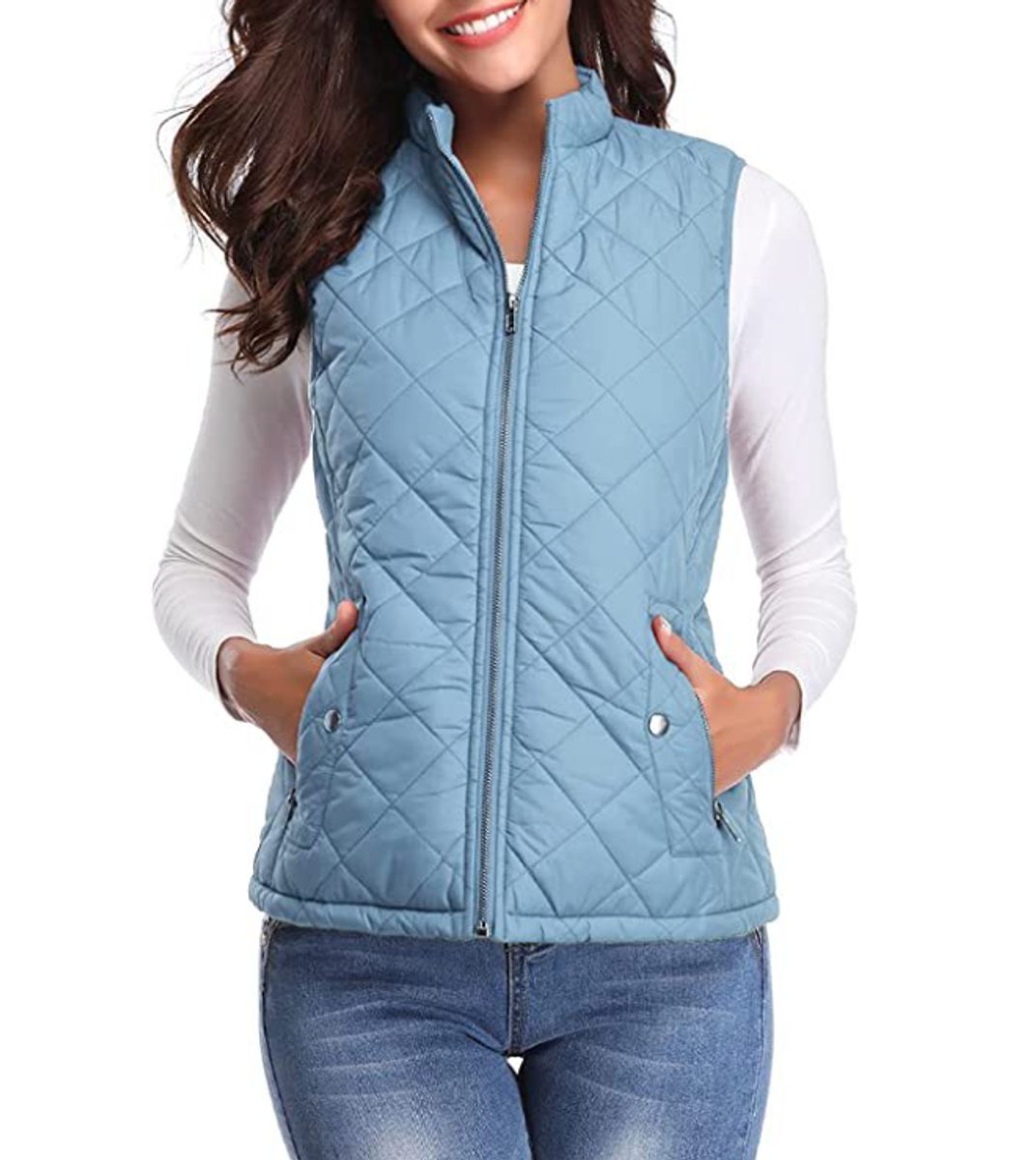 Front view of a model wearing the diamond-quilted zip-up vest with stand collar in light blue over a white long-sleeve top.