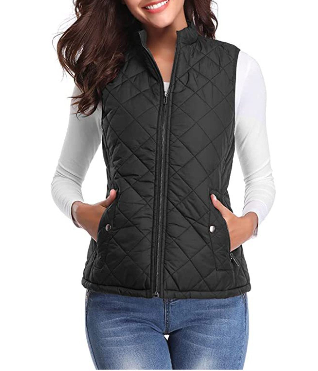 Front view of a model wearing the diamond-quilted zip-up vest with stand collar in classic black over a white top and blue jeans.