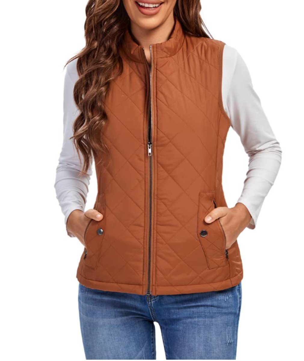 Front view of a model wearing the diamond-quilted zip-up vest with stand collar in warm caramel brown paired with blue denim jeans.