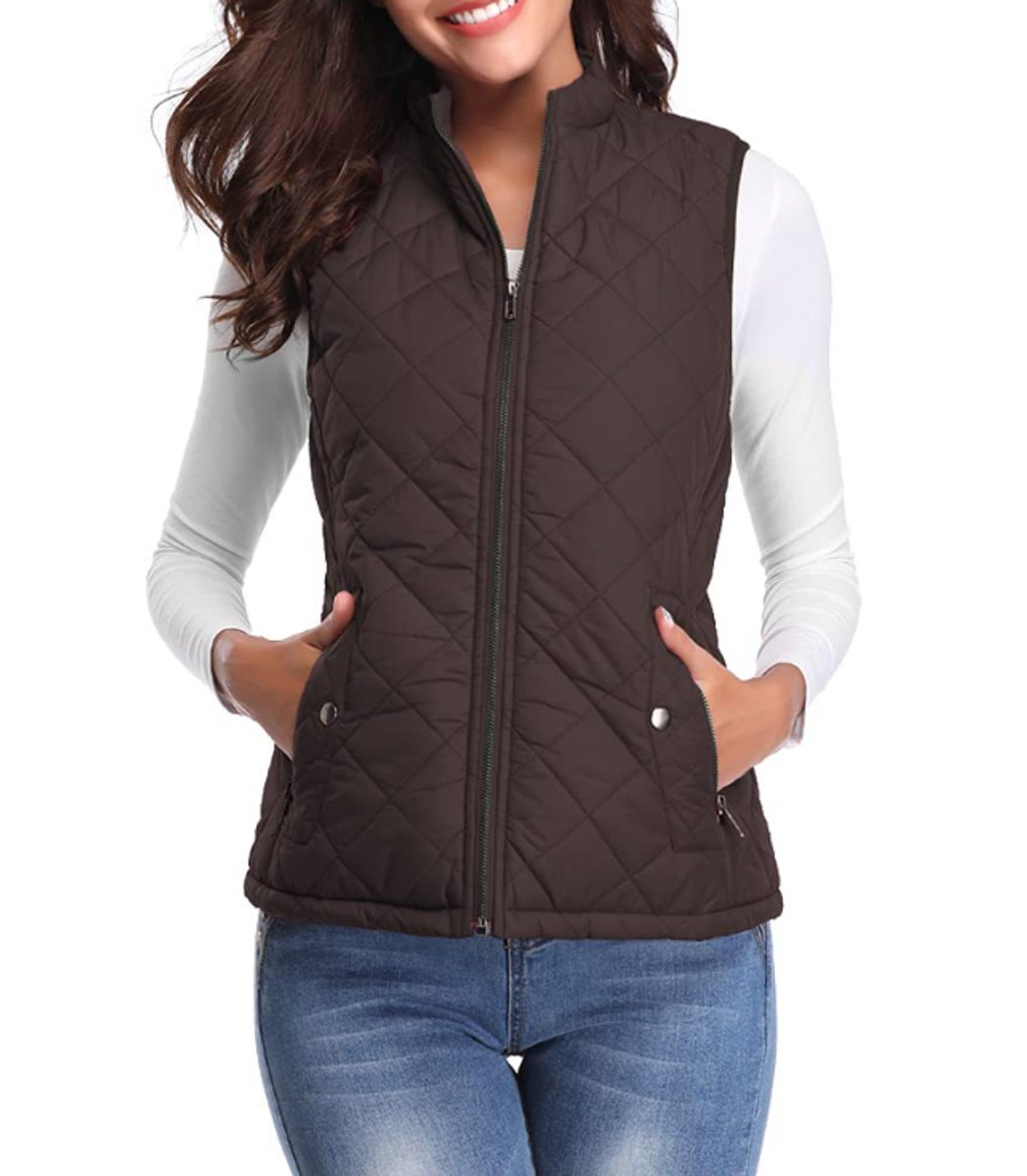 Front view of a model wearing the diamond-quilted zip-up vest with stand collar in dark chocolate brown paired with blue jeans.