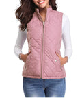 Full-length front view of a model wearing a dusty pink diamond-quilted zip-up vest featuring a high stand collar, full zipper front, and snap-tab side pockets, paired with a white long-sleeve top and blue denim jeans.