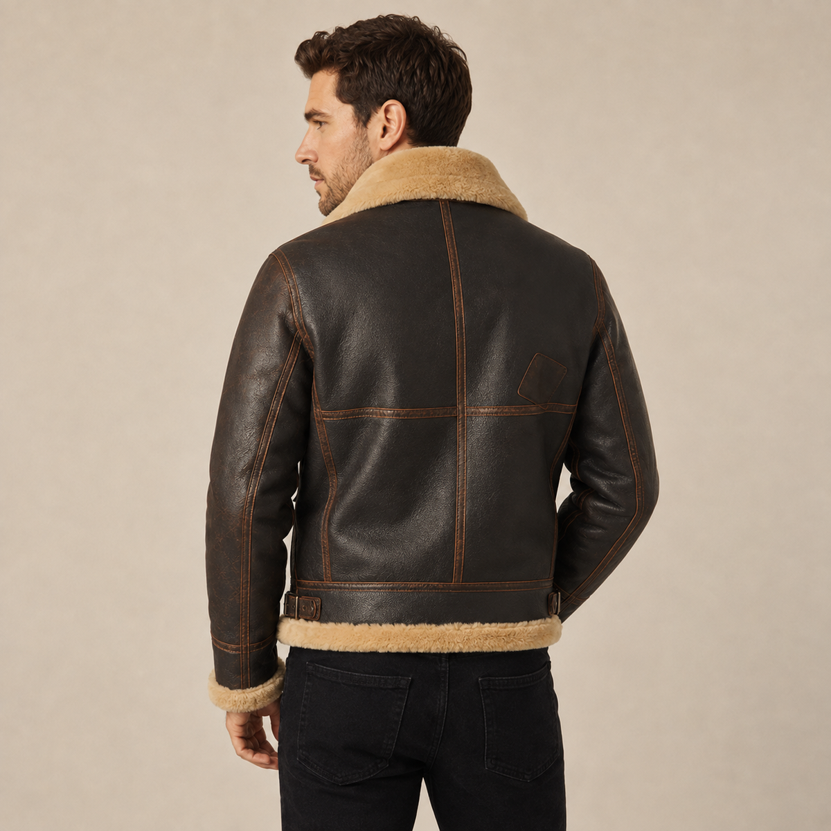 Distressed brown leather aviator jacket with a shearling lapel collar and structured fit worn by a man.