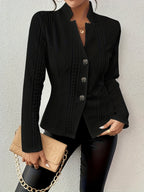 Black cotton blend short coat with embossed diamond texture, stand collar, and button-front closure in a tailored fit.