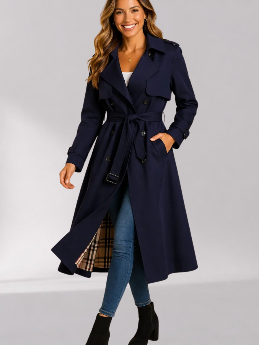 Navy Double-Breasted Belted Longline Trench Coat worn by a female model, featuring a storm flap, epaulets, strap cuffs, and belted waist.