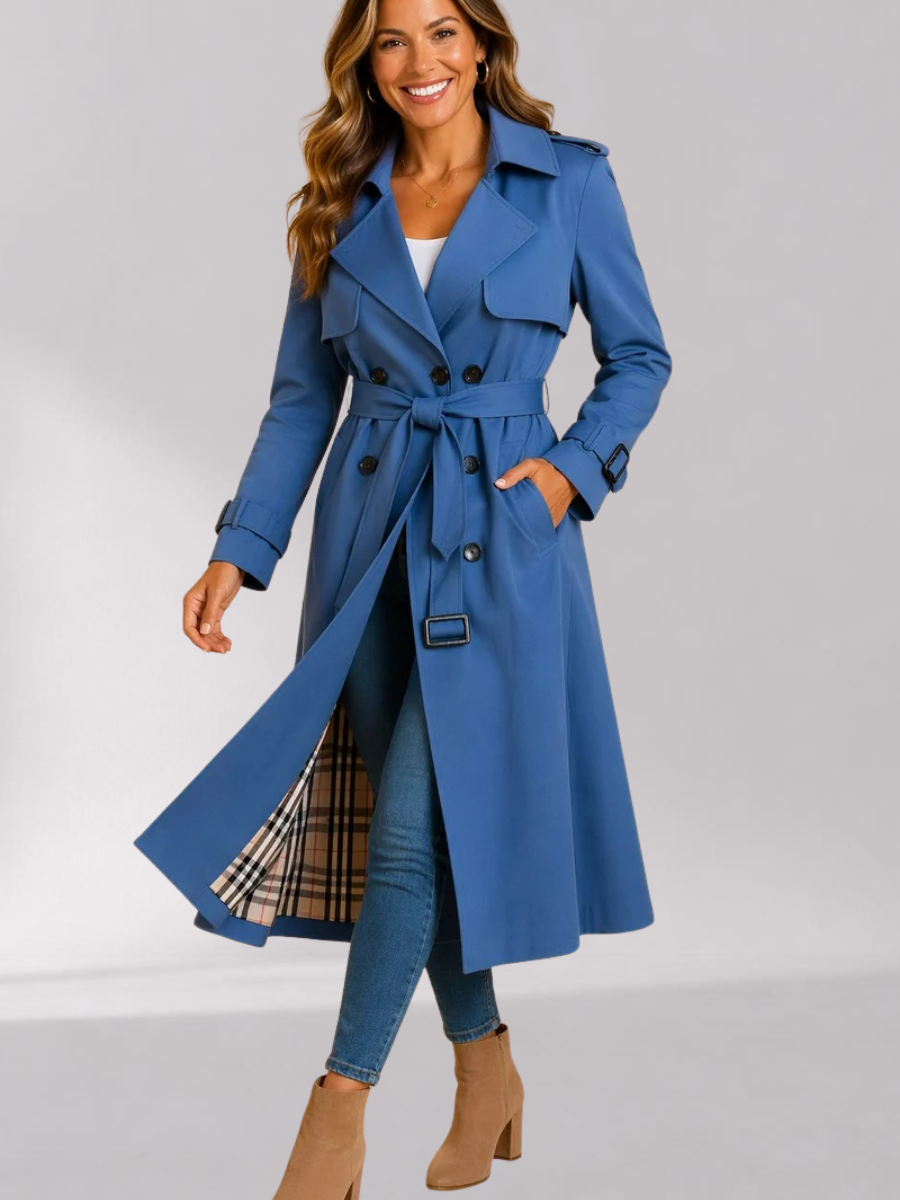Blue Double-Breasted Belted Longline Trench Coat worn by a female model, featuring a storm flap, epaulets, strap cuffs, and belted waist.