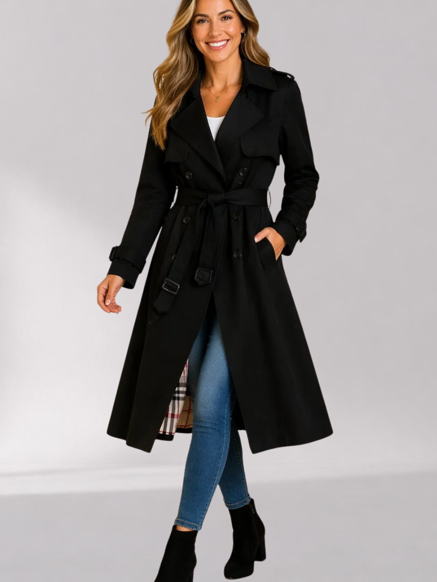 Black Double-Breasted Belted Longline Trench Coat worn by a female model, featuring a storm flap, epaulets, strap cuffs, button front, and belted waist.