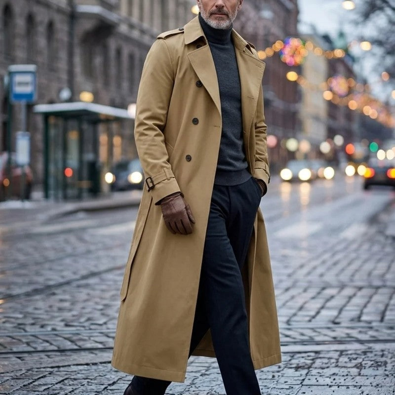 Tan Double-Breasted Longline Trench Coat worn by a male model, featuring a belted waist, notch lapels, double-breasted button front, and belted cuffs.