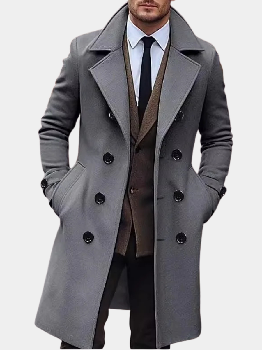 Gray Double-Breasted Midi Trench Coat worn by a male model, featuring wide notch lapels, double-breasted button front, long sleeves, and a tailored midi-length silhouette.