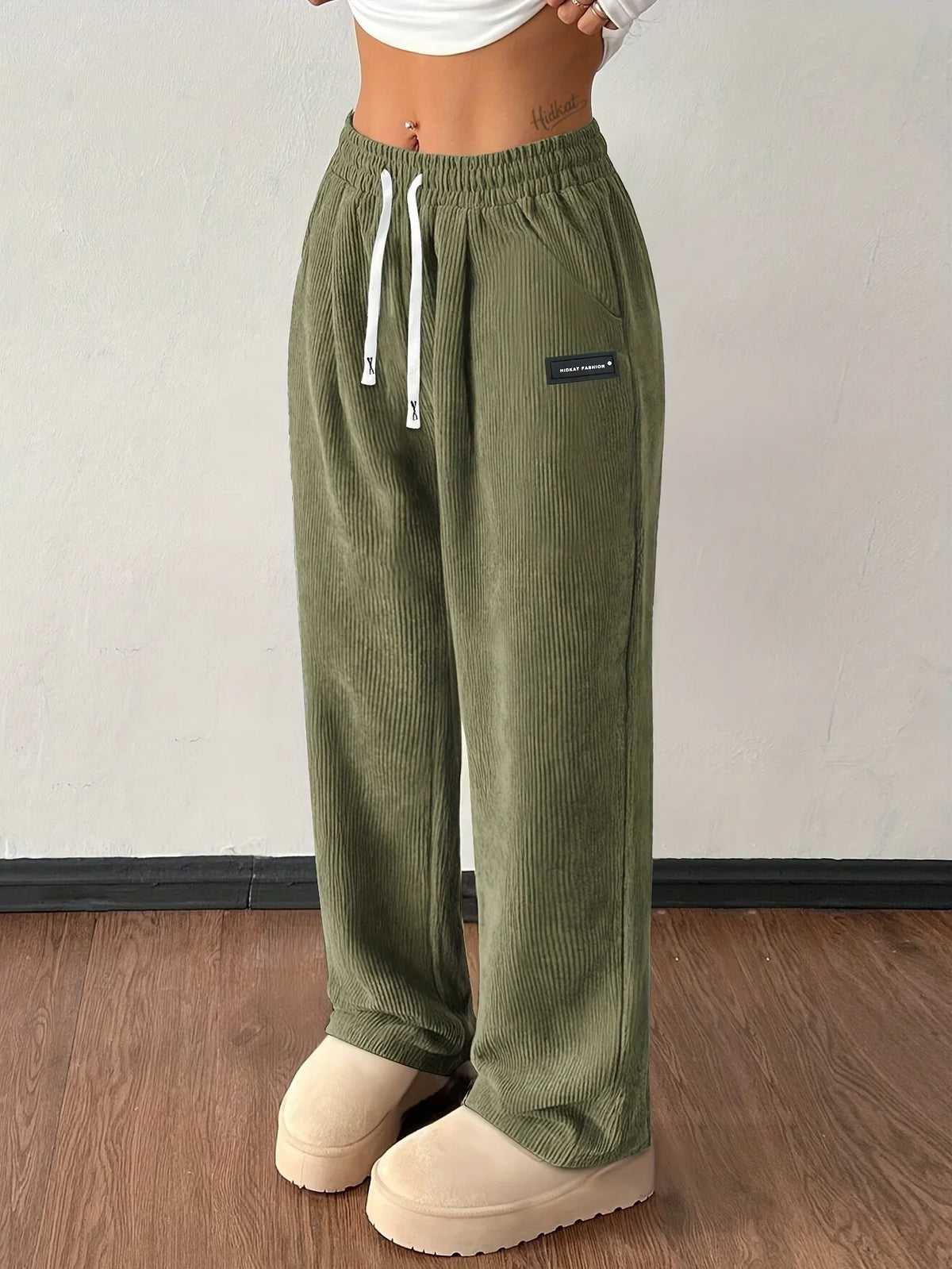 Green wide-leg corduroy pants with elastic high waist and drawstring