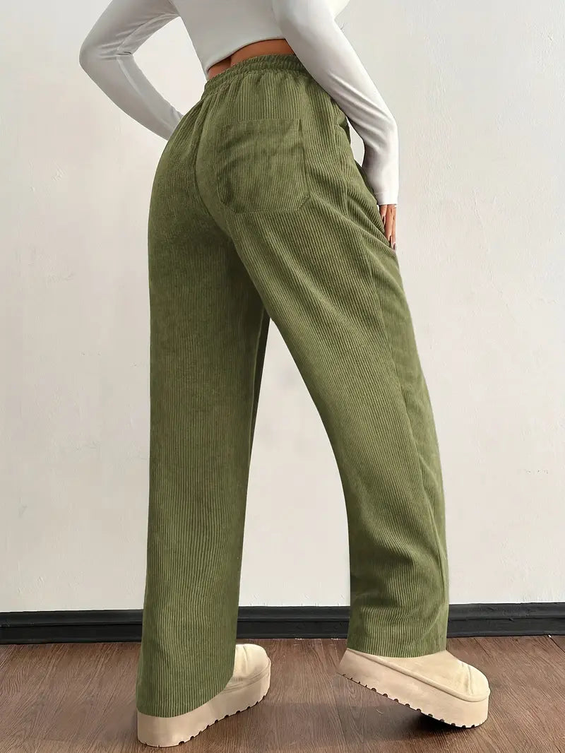 Green corduroy pants shown from the side with wide-leg fit