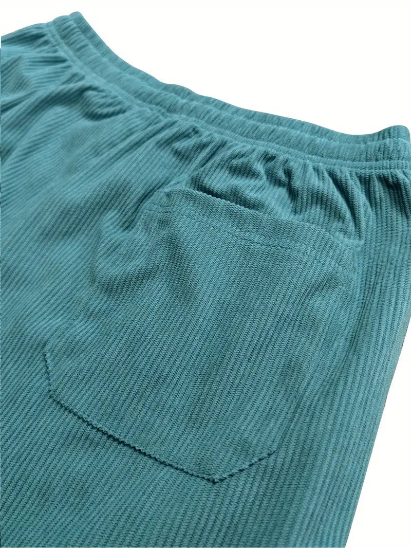 Close-up of teal corduroy fabric and elastic waistband